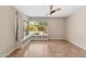 A bright living room with a bay window overlooking the pool and yard with built in shelving at 1749 W Monterosa St, Phoenix, AZ 85015