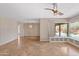 A spacious living room with a bay window with built in shelving and views of the outdoor pool at 1749 W Monterosa St, Phoenix, AZ 85015
