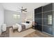 Stylishly furnished bedroom with wood floors, accent wall art, and mirrored closet at 1749 W Monterosa St, Phoenix, AZ 85015