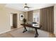 Well-lit home office with neutral tones, a sleek desk, and elegant curtains at 1749 W Monterosa St, Phoenix, AZ 85015