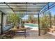 Covered outdoor patio with table, potted plants, and a view of the refreshing pool at 1749 W Monterosa St, Phoenix, AZ 85015