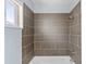 Modern bathroom featuring a tiled shower with a shower head and window at 1749 W Monterosa St, Phoenix, AZ 85015