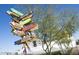 Whimsical signpost pointing to local businesses, with an artistic touch and blue sky backdrop at 1749 W Monterosa St, Phoenix, AZ 85015