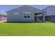 Picture of the back exterior of the house with low maintenance artificial grass at 17704 W Fetlock Trl, Surprise, AZ 85387