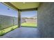Covered back patio and artificial grass provide a lovely outdoor living space at 17704 W Fetlock Trl, Surprise, AZ 85387