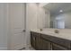 Bathroom featuring double sink vanity, large mirror and tile flooring at 17704 W Fetlock Trl, Surprise, AZ 85387