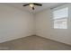 Neutral bedroom with carpet, ceiling fan, and window with natural light at 17704 W Fetlock Trl, Surprise, AZ 85387