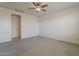 Bedroom features carpet, ceiling fan, and a nearby door at 17704 W Fetlock Trl, Surprise, AZ 85387