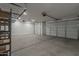 Spacious three car garage with high ceilings, recessed lights, and concrete flooring at 17704 W Fetlock Trl, Surprise, AZ 85387
