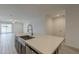 Modern kitchen features a stainless steel sink, a pull-down faucet, and gray cabinets at 17704 W Fetlock Trl, Surprise, AZ 85387