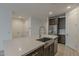 Kitchen island with stainless steel sink, quartz countertop, and stainless steel refrigerator at 17704 W Fetlock Trl, Surprise, AZ 85387