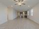 Open-concept living room features light-colored walls, wood-look tile flooring, and recessed lighting at 17704 W Fetlock Trl, Surprise, AZ 85387