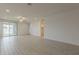 Open-concept living area features wood-look tile flooring, a ceiling fan, and recessed lighting at 17704 W Fetlock Trl, Surprise, AZ 85387