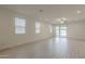 Bright and airy living room with tile flooring, ceiling fan, and sliding glass doors to the backyard at 17704 W Fetlock Trl, Surprise, AZ 85387