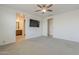 Spacious main bedroom with en suite bathroom access and television at 17704 W Fetlock Trl, Surprise, AZ 85387