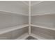 Walk-in pantry offers ample storage space with built-in shelving for organized storage at 17704 W Fetlock Trl, Surprise, AZ 85387