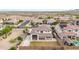 Aerial view of home with ample parking, desert landscaping, privacy fence, and a backyard with green grass at 19026 W Becker Ln, Surprise, AZ 85388