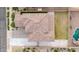 Aerial view of roof tiles and landscaped backyard featuring green grass, desert landscaping, and privacy fence at 19026 W Becker Ln, Surprise, AZ 85388