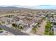 An aerial view of a neighborhood featuring homes with desert landscaping and mountain views at 19026 W Becker Ln, Surprise, AZ 85388