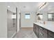 Modern bathroom with a glass-enclosed shower, sleek vanity, tile flooring, and stylish fixtures at 19026 W Becker Ln, Surprise, AZ 85388