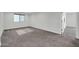 This carpeted bedroom offers a serene space with natural light and ample room at 19026 W Becker Ln, Surprise, AZ 85388