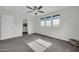 A bedroom with a ceiling fan, a closet with rods, and three windows with coverings at 19026 W Becker Ln, Surprise, AZ 85388