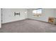 Bright bedroom with carpet, window, and neutral paint, ready for personalization and comfortable living at 19026 W Becker Ln, Surprise, AZ 85388