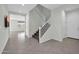 Inviting entryway featuring neutral tones, tile floors, and staircase leading to the upper level at 19026 W Becker Ln, Surprise, AZ 85388