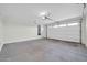Spacious two car garage featuring concrete flooring and a white, paneled garage door at 19026 W Becker Ln, Surprise, AZ 85388