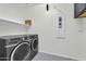 A laundry room with a shelf, laundry machine and dryer at 19026 W Becker Ln, Surprise, AZ 85388