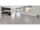 Open-concept living room featuring tile flooring, recessed lighting, and sliding glass doors to the backyard at 19026 W Becker Ln, Surprise, AZ 85388