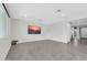 Spacious living room with neutral paint, tile floors, modern lighting, and a view of the backyard at 19026 W Becker Ln, Surprise, AZ 85388
