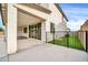 An outdoor patio with a grassy yard and metal fence at 19026 W Becker Ln, Surprise, AZ 85388