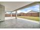 Spacious covered patio with concrete flooring and a view of the large, enclosed backyard at 19026 W Becker Ln, Surprise, AZ 85388