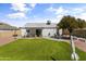 Expansive backyard with artificial turf, desert landscaping, and outdoor seating area at 19039 N 47Th Ave, Glendale, AZ 85308
