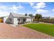 Large backyard with artificial turf, desert landscaping, and a covered patio at 19039 N 47Th Ave, Glendale, AZ 85308
