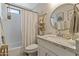 Bright bathroom featuring a shower with a white curtain and a granite vanity with round mirror at 19039 N 47Th Ave, Glendale, AZ 85308