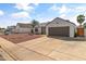 Single-story home with desert landscaping, gray roof, two-car garage and extended driveway at 19039 N 47Th Ave, Glendale, AZ 85308