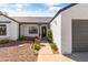 Inviting front entrance with desert landscaping, a gray roof, and a covered porch at 19039 N 47Th Ave, Glendale, AZ 85308