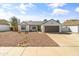 Inviting single-story home with desert landscaping, a gray roof, and a two-car garage at 19039 N 47Th Ave, Glendale, AZ 85308