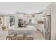 Bright kitchen featuring white cabinets, stainless appliances, granite counters and island with seating at 19039 N 47Th Ave, Glendale, AZ 85308