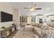 Spacious living room featuring a large sectional sofa, and backyard access at 19039 N 47Th Ave, Glendale, AZ 85308