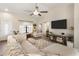 Bright living room with vaulted ceilings, wood-look flooring, and comfortable neutral furniture at 19039 N 47Th Ave, Glendale, AZ 85308