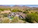 Expansive property showcases lush landscaping, a pristine pool, and breathtaking desert mountain views at 19296 N 98Th Pl, Scottsdale, AZ 85255