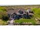 Stunning aerial shot of home showcasing impeccable landscaping, hardscaping, and pristine desert surroundings at 19296 N 98Th Pl, Scottsdale, AZ 85255