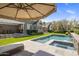 Backyard oasis with a pool, spa, covered patio, and meticulous landscaping, ideal for upscale outdoor entertaining at 19296 N 98Th Pl, Scottsdale, AZ 85255
