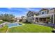 Beautiful backyard featuring a pool, covered patio, and lush lawn, perfect for outdoor living and entertaining at 19296 N 98Th Pl, Scottsdale, AZ 85255