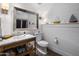Charming bathroom featuring a marble vanity, decorative mirror, and nautical accents at 19296 N 98Th Pl, Scottsdale, AZ 85255