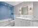 Bright bathroom featuring blue tiled shower over tub and white marble vanity at 19296 N 98Th Pl, Scottsdale, AZ 85255