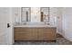Elegant bathroom with double sink vanity, warm lighting, patterned floors, and lots of storage at 19296 N 98Th Pl, Scottsdale, AZ 85255
